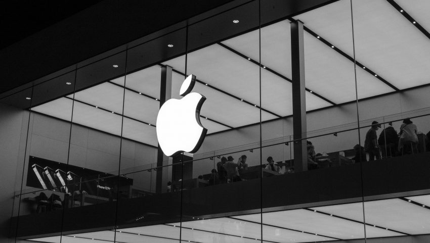 The iconic Apple logo on the front of an Apple store.